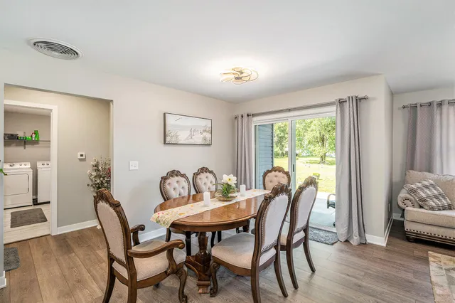 a dining room with furniture and window