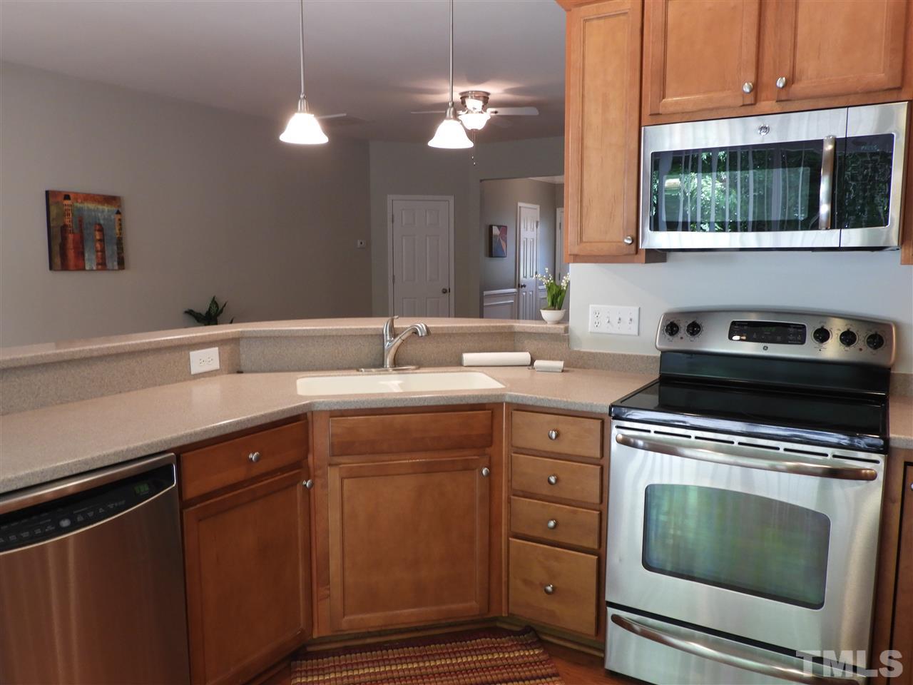 7245 Racine Way Raleigh, NC 27690 - Photo 11 of 29 a kitchen with a sink stove and microwave