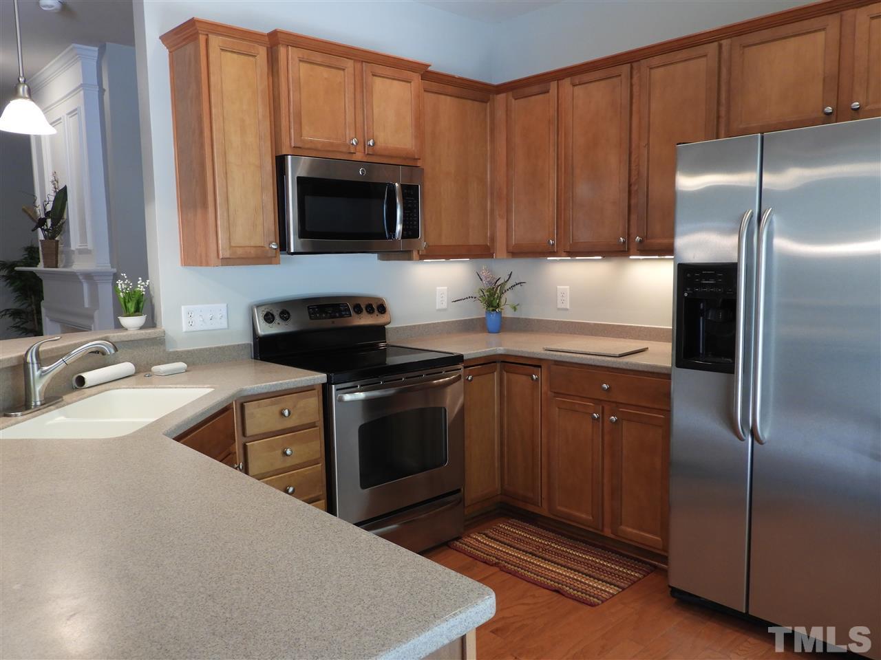 7245 Racine Way Raleigh, NC 27690 - Photo 12 of 29 a kitchen with a sink stove and microwave