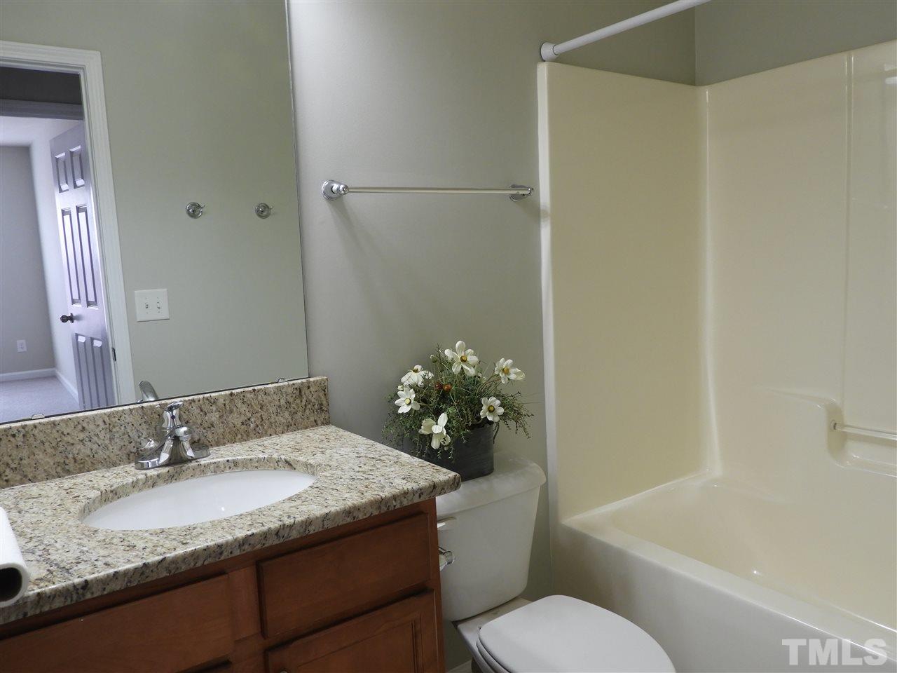 7245 Racine Way Raleigh, NC 27690 - Photo 15 of 29 a bathroom with a granite countertop sink toilet and shower