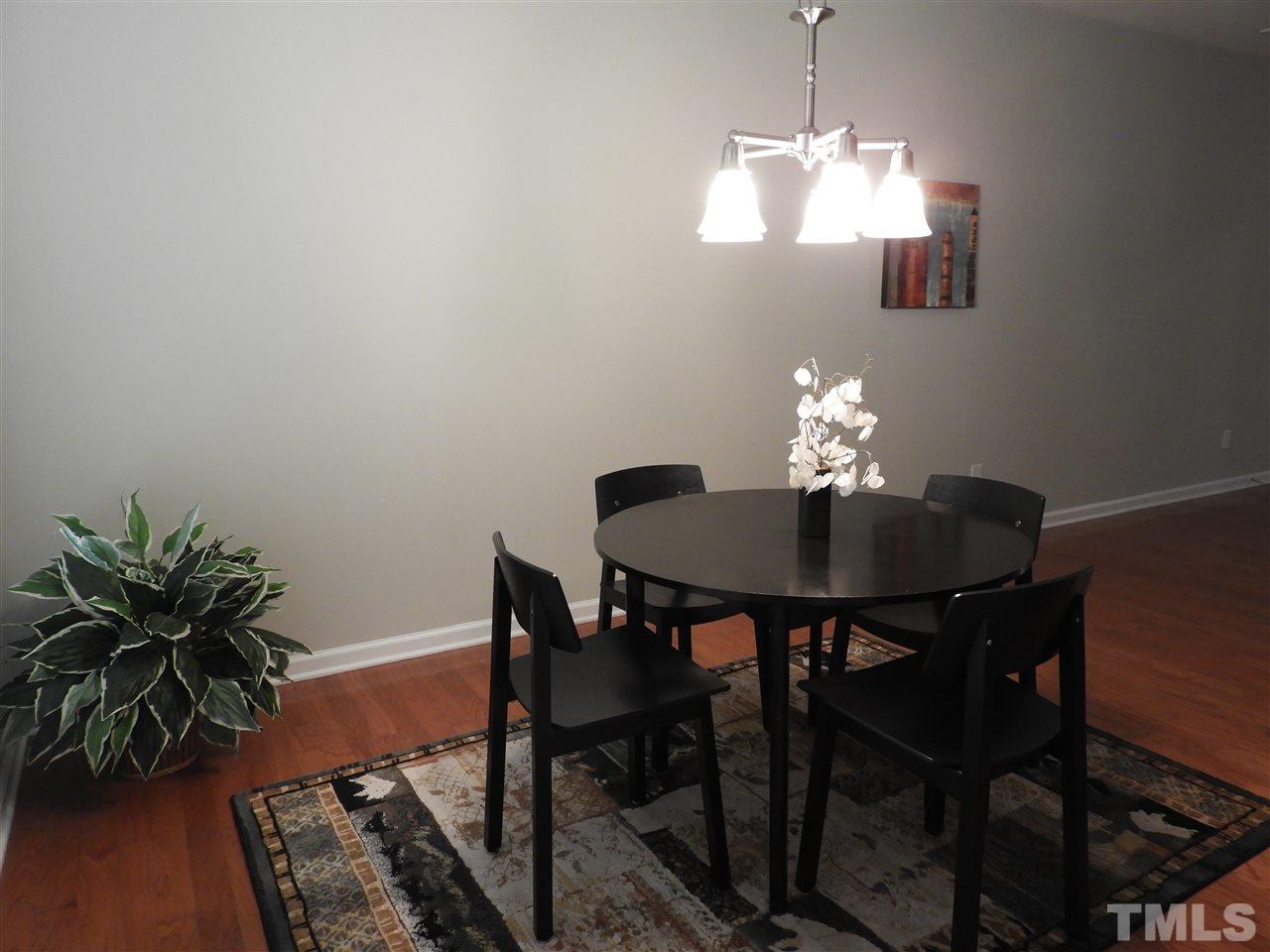 7245 Racine Way Raleigh, NC 27690 - Photo 28 of 29 a dining room with furniture and wooden floor
