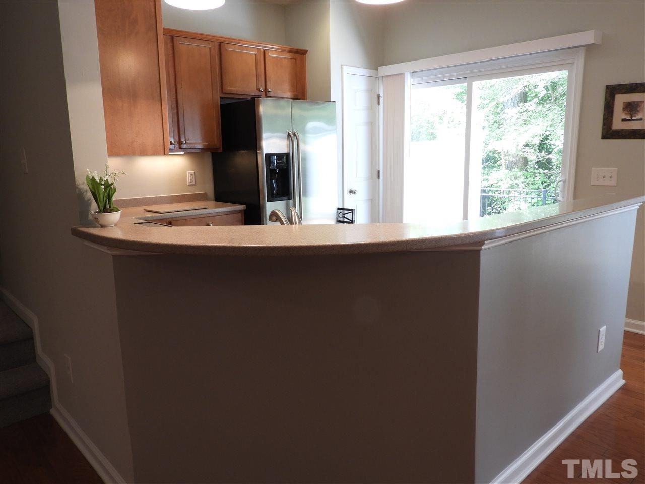 7245 Racine Way Raleigh, NC 27690 - Photo 10 of 29 a kitchen with stainless steel appliances a sink and a refrigerator