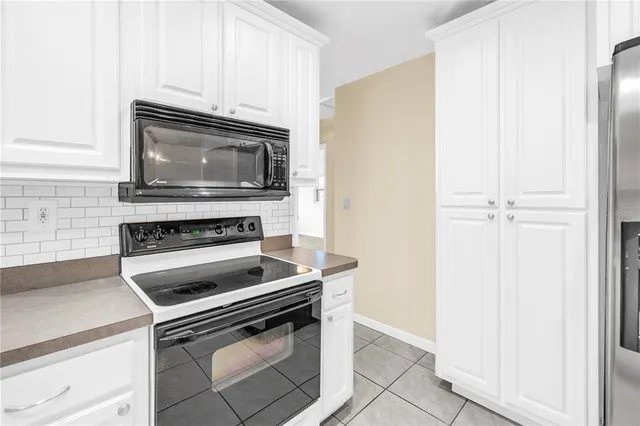 a kitchen with granite countertop cabinets and steel stainless steel appliances