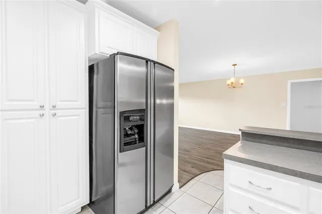 a kitchen with a refrigerator and cabinets