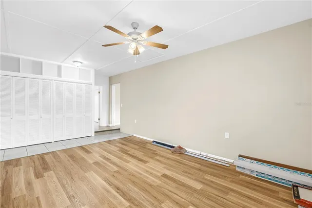 a view of a bathroom with toilet window and wooden floor