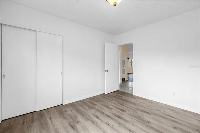 a view of an empty room and wooden floor