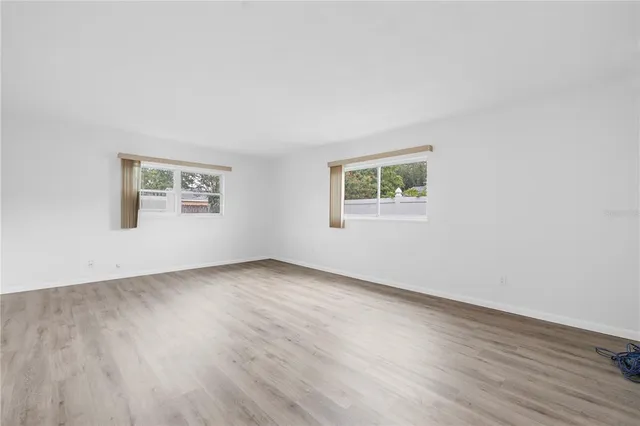a view of an empty room and wooden floor