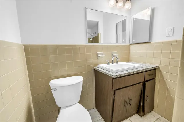 a view of an empty room with wooden floor and a balcony
