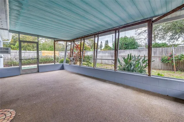 a view of a room with wooden walls and a large window
