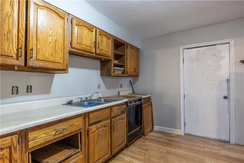 a kitchen with stainless steel appliances granite countertop a sink stove and cabinets