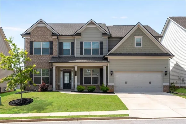 a front view of a house with a yard