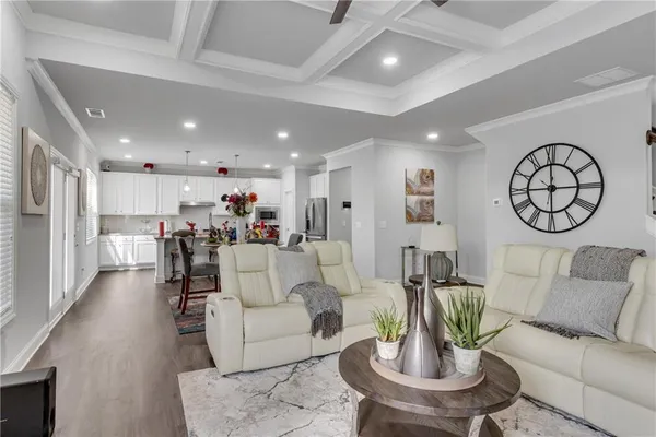 a dining room with furniture and wooden floor