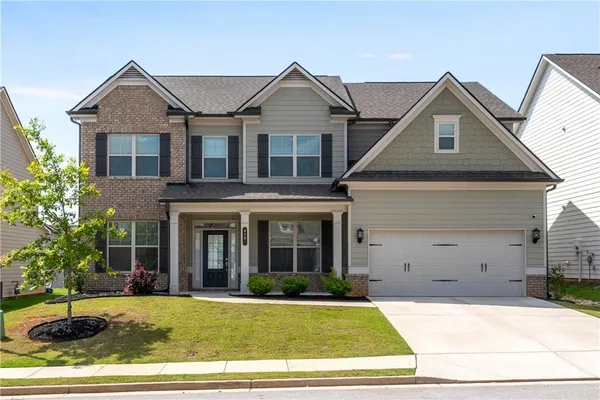 a front view of a house with a yard