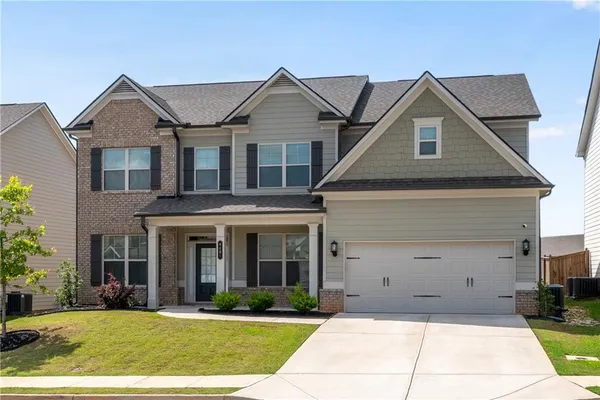 a front view of a house with a yard