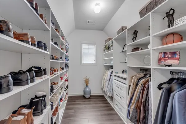 a bathroom with a sink a toilet a mirror and shower curtain