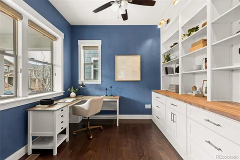 a view of a workspace with furniture and a window
