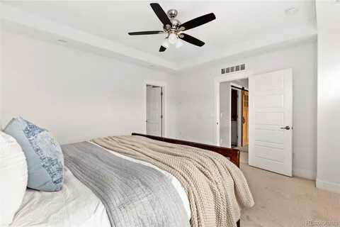 a bedroom with a bed and a ceiling fan