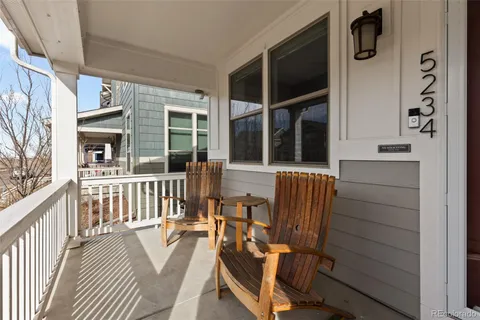 a view of a two chairs and table in the balcony