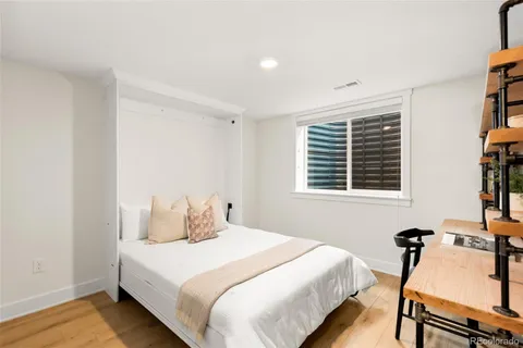 a bedroom with a bed and a table