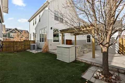 a view of a house with backyard and sitting area