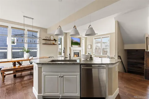 a kitchen with granite countertop a sink and a stove