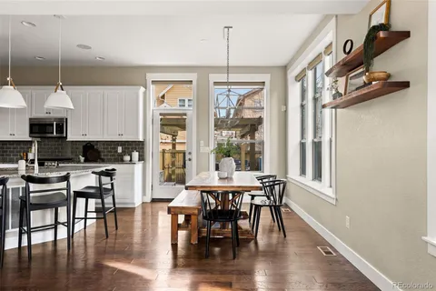 a view of a dining room with furniture window and wooden floor