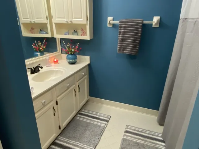 a bathroom with a sink a vanity and a mirror