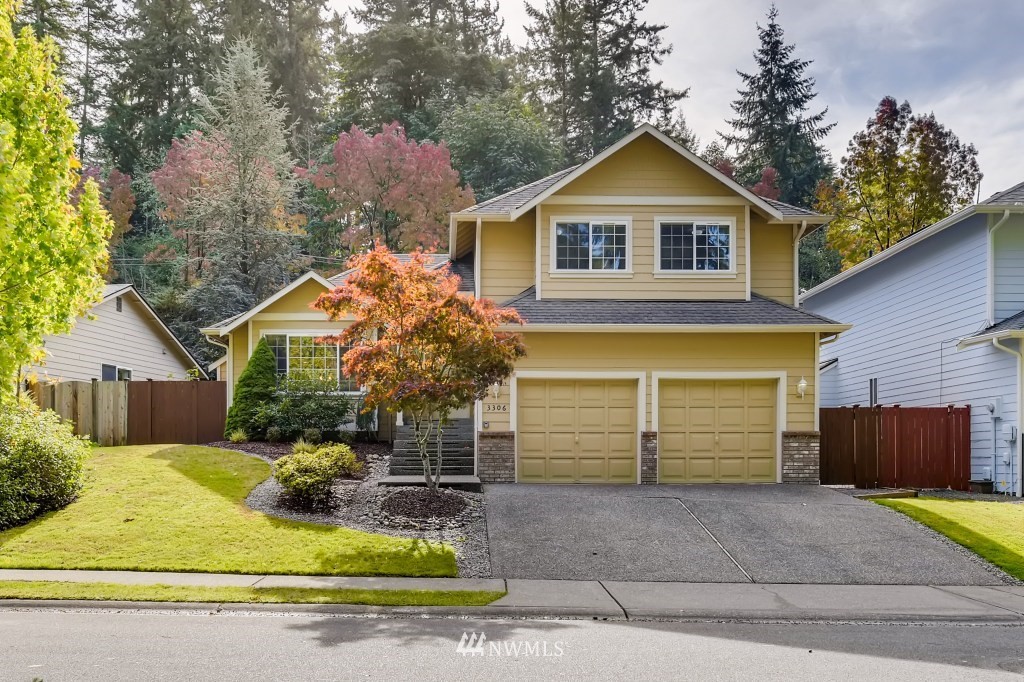 3306 201st Place Southeast Bothell, WA 98012 - Photo 1 of 28 a front view of a house with a yard and garage