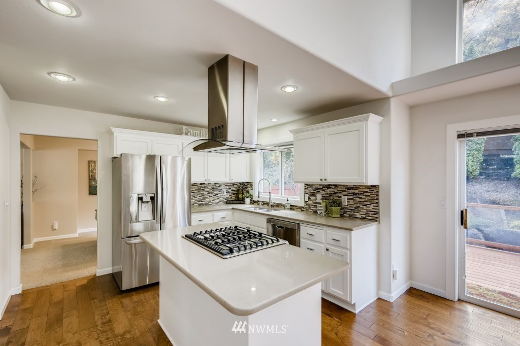 3306 201st Place Southeast Bothell, WA 98012 - Photo 2 of 28 a kitchen with a stove a refrigerator and wooden floor