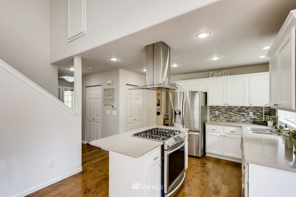 3306 201st Place Southeast Bothell, WA 98012 - Photo 12 of 28 a kitchen with granite countertop a sink stove and refrigerator