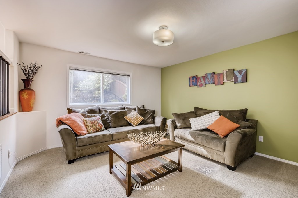 3306 201st Place Southeast Bothell, WA 98012 - Photo 17 of 28 a living room with furniture and a large window