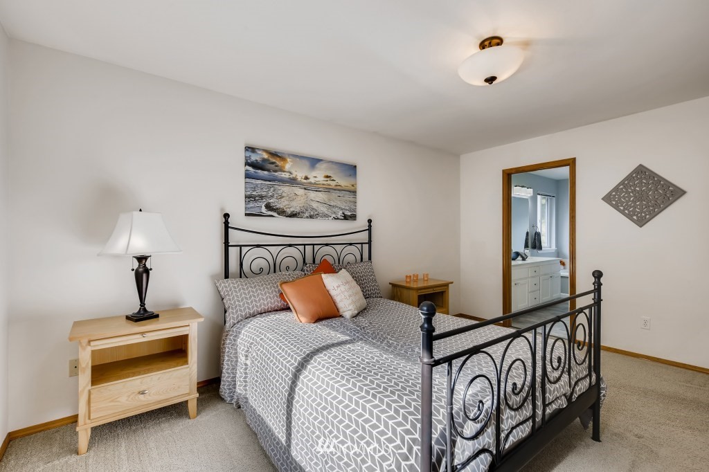 3306 201st Place Southeast Bothell, WA 98012 - Photo 18 of 28 a bedroom with bed and wooden floor