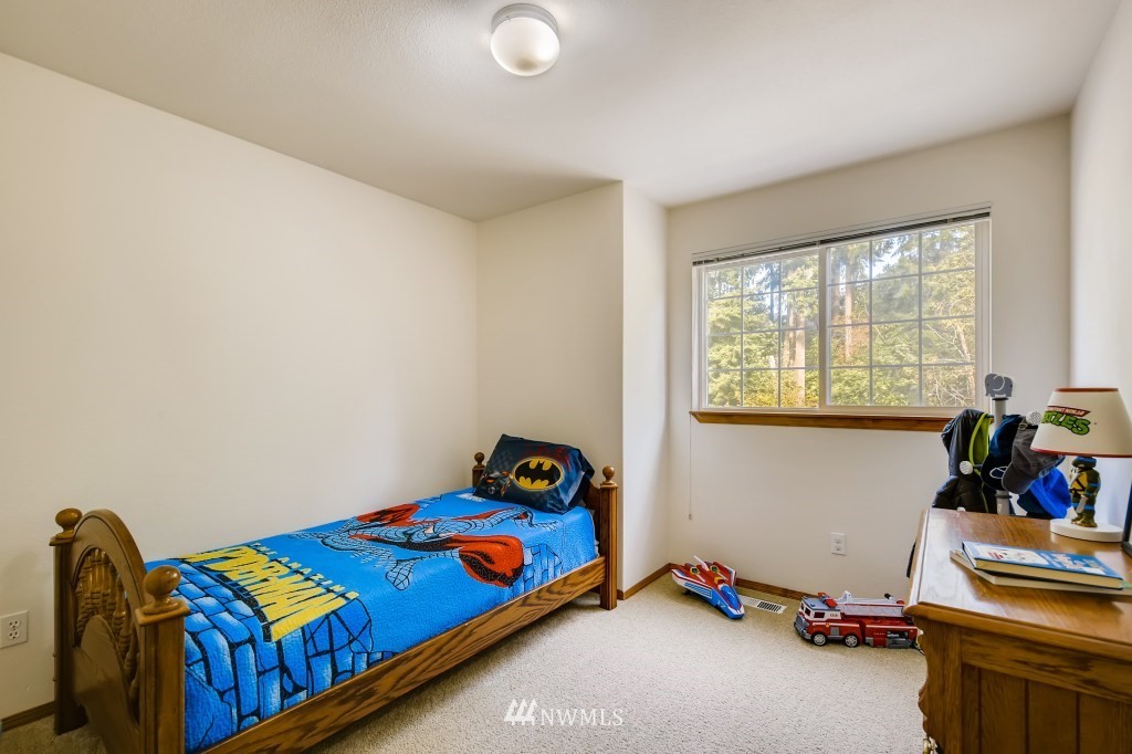 3306 201st Place Southeast Bothell, WA 98012 - Photo 19 of 28 a bedroom with a bed and a window