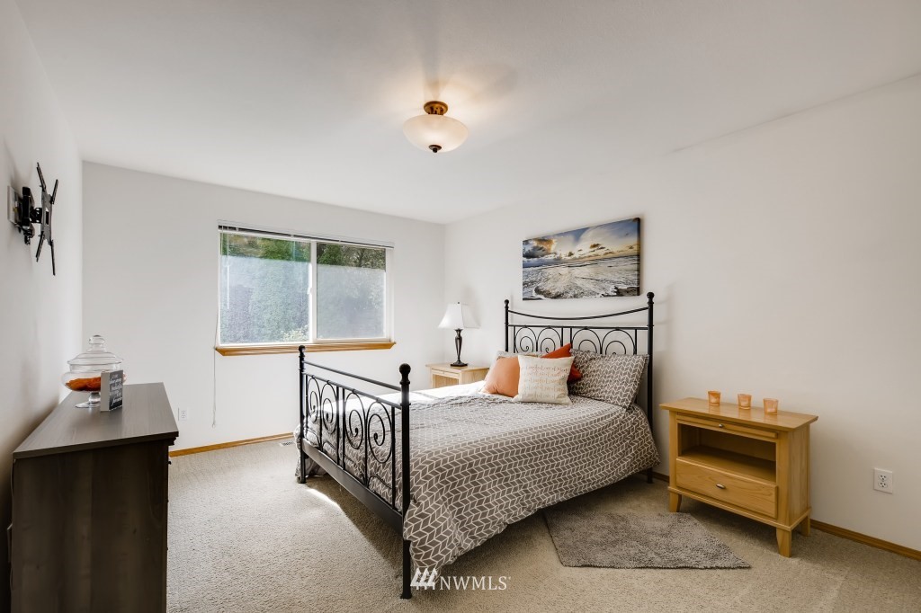 3306 201st Place Southeast Bothell, WA 98012 - Photo 20 of 28 a bedroom with a bed and a window
