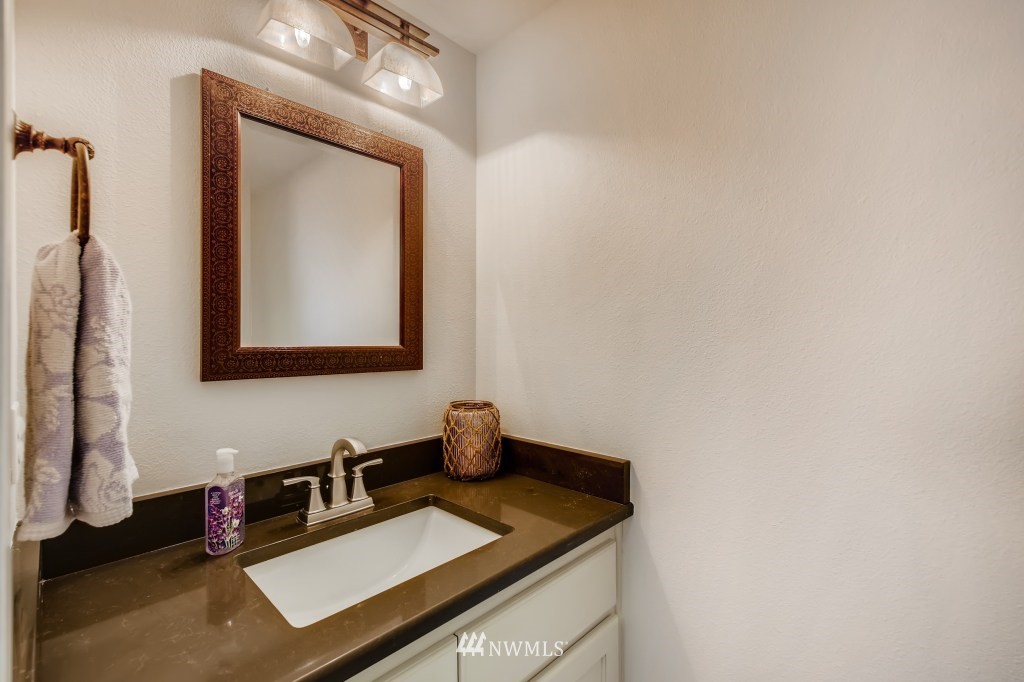 3306 201st Place Southeast Bothell, WA 98012 - Photo 23 of 28 a bathroom with a toilet sink and mirror