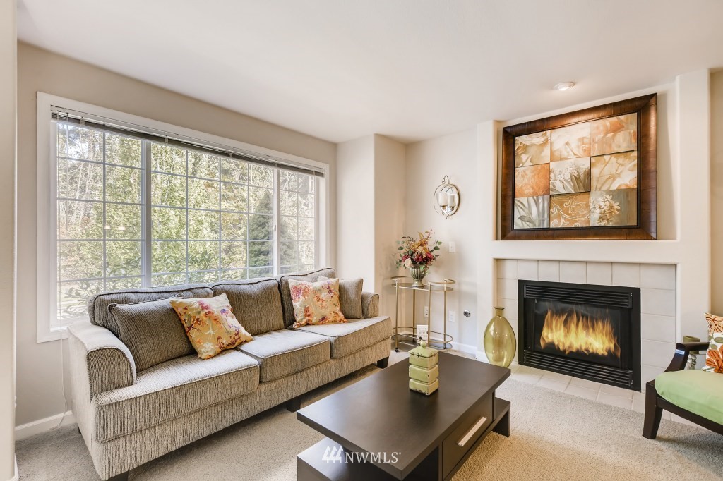 3306 201st Place Southeast Bothell, WA 98012 - Photo 4 of 28 a living room with furniture a fireplace and a large window
