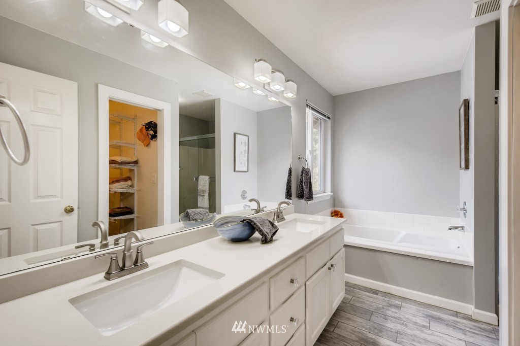 3306 201st Place Southeast Bothell, WA 98012 - Photo 5 of 28 a bathroom with a double vanity sink mirror double and bathtub