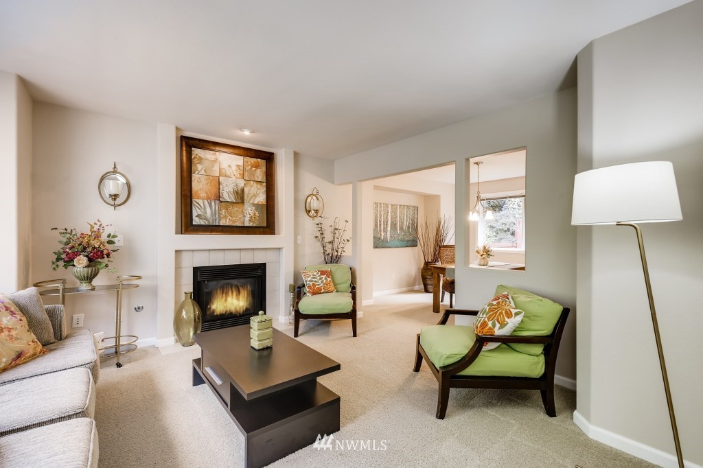 3306 201st Place Southeast Bothell, WA 98012 - Photo 8 of 28 a living room with furniture and a fireplace