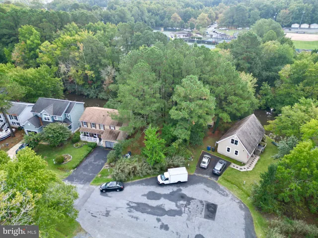 an aerial view of a house with garden space and street view