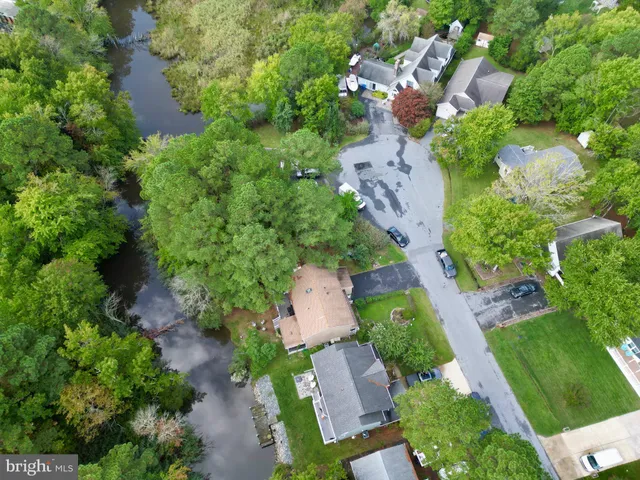an aerial view of a house with a yard and lake view