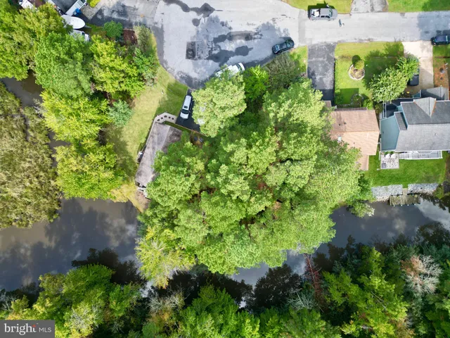 an aerial view of a house with a yard and garden