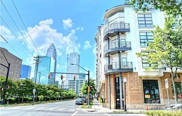 a front view of a multi story residential apartment building with a yard