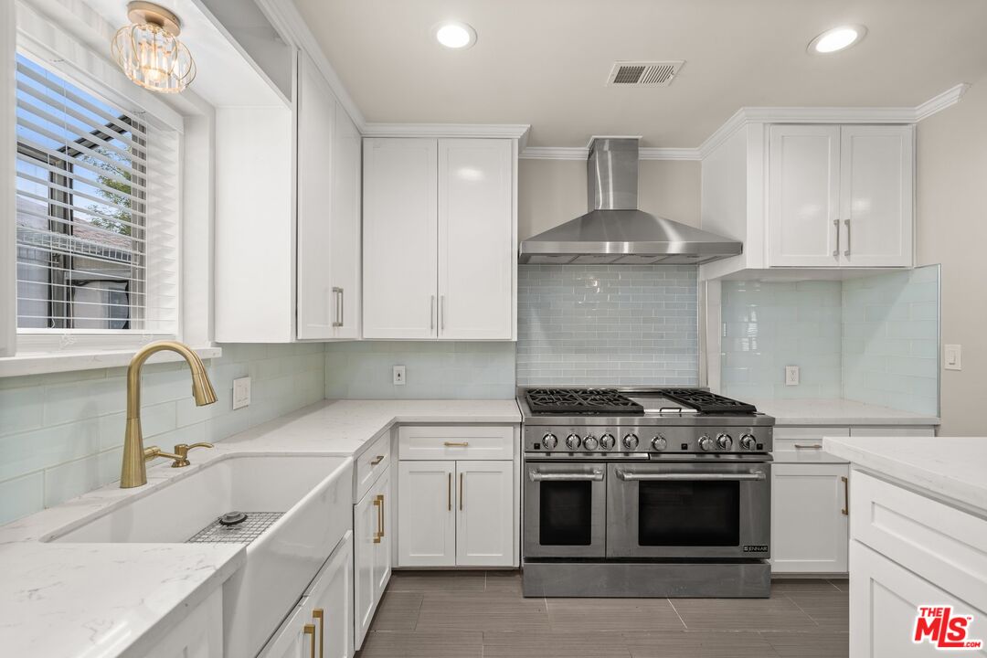 529 Coolidge Drive San Gabriel, CA 91775 - Photo 5 of 11 a kitchen with a stove sink and cabinets