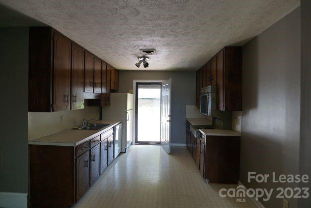 464 Steel Bridge Loop, Unit B Hickory, NC 28601 - Photo 2 of 7 a kitchen with stainless steel appliances granite countertop a refrigerator and a stove top oven