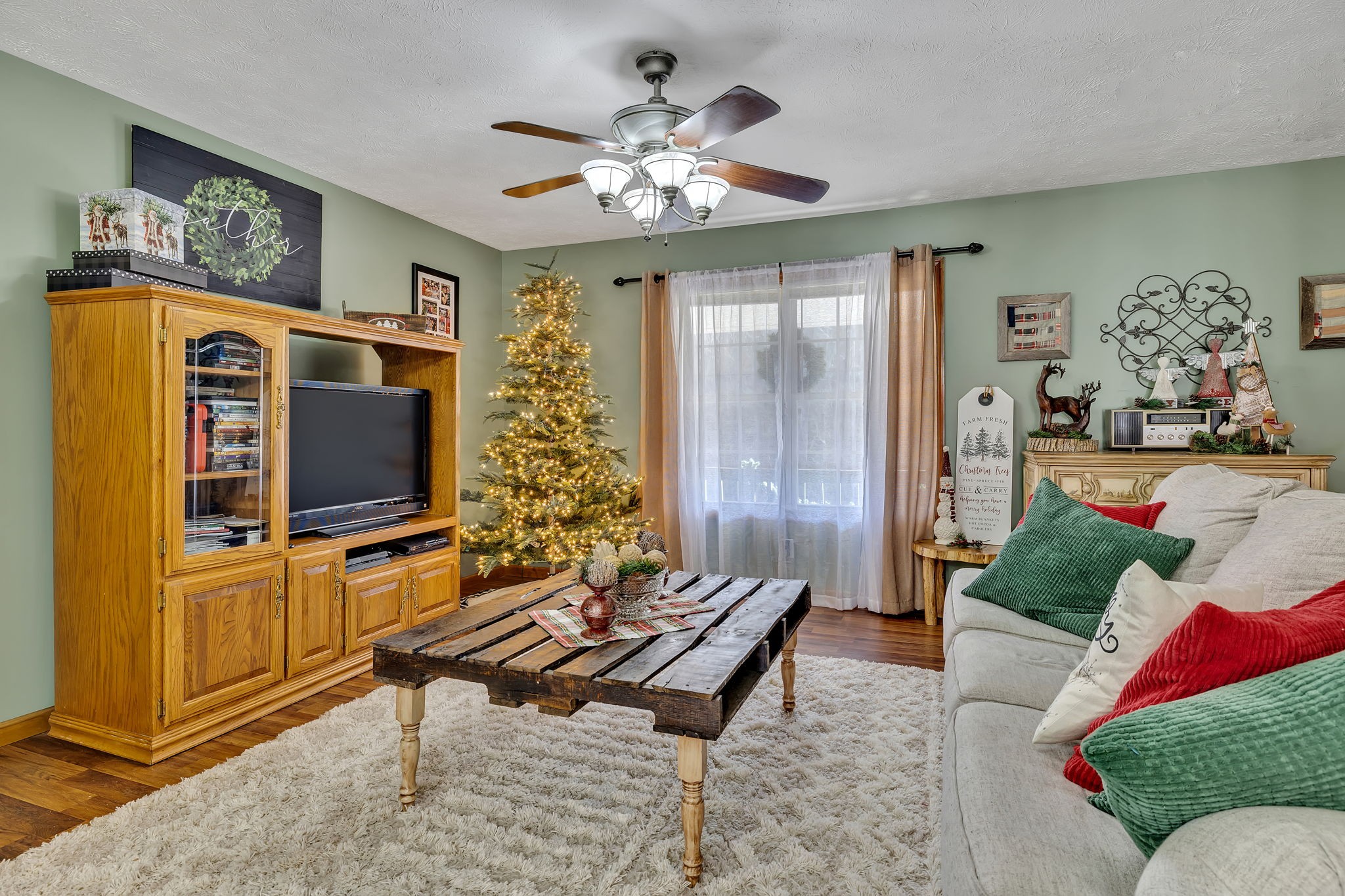 293 Slippery Road Hohenwald, TN 38462 - Photo 13 of 36 a living room with furniture and a flat screen tv