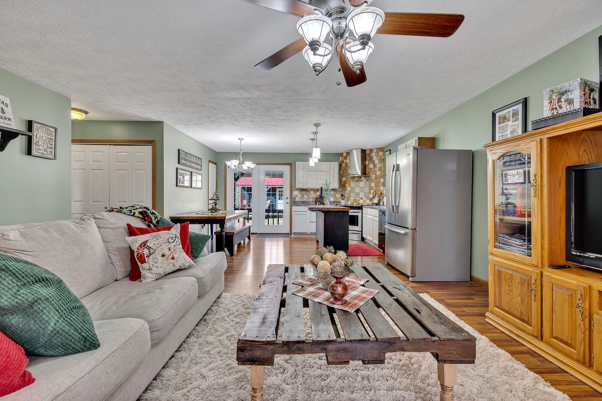 293 Slippery Road Hohenwald, TN 38462 - Photo 14 of 36 a living room with furniture flat screen tv and a dining table
