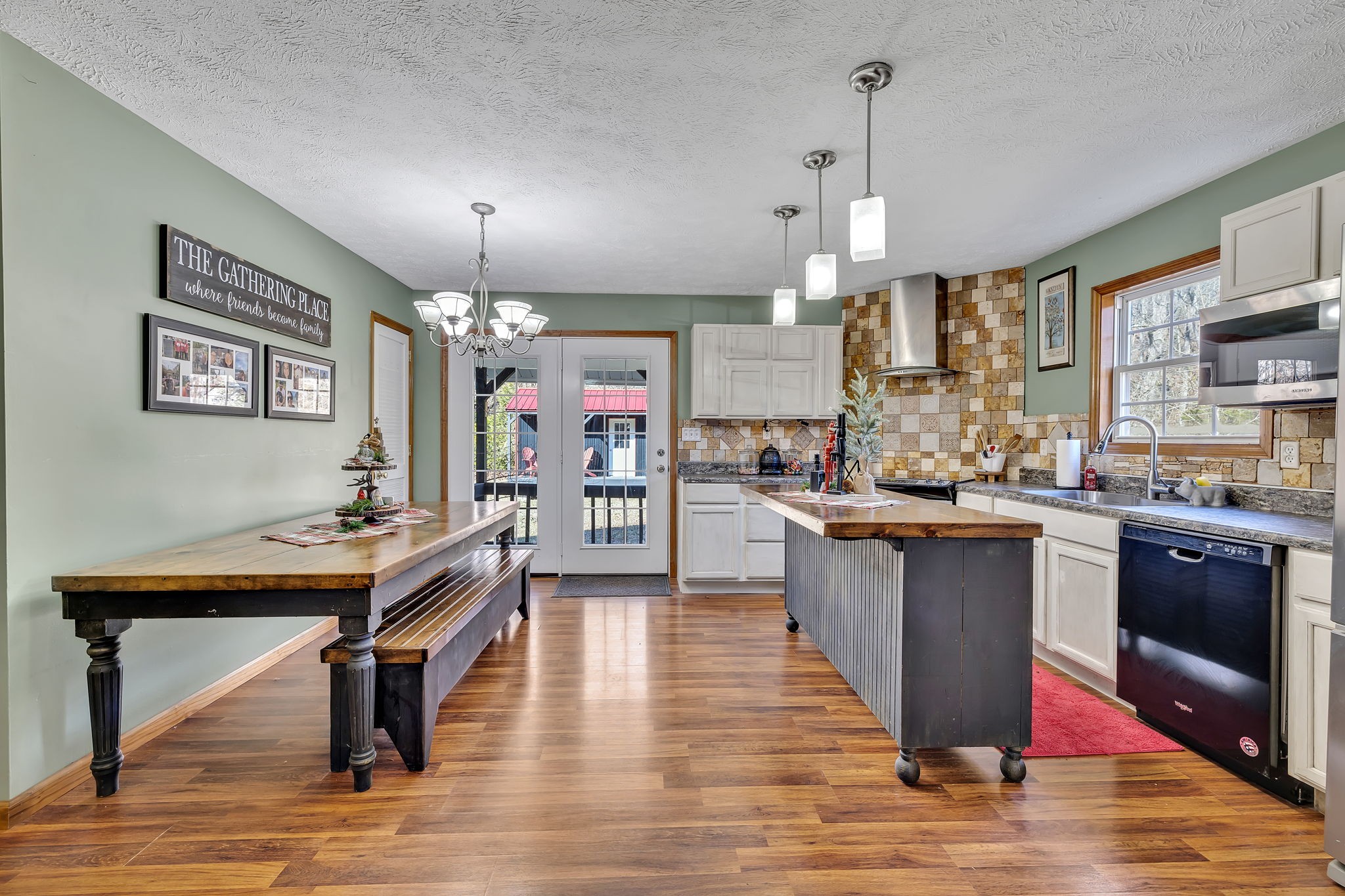 293 Slippery Road Hohenwald, TN 38462 - Photo 15 of 36 a kitchen with stainless steel appliances kitchen island granite countertop a table chairs in it and wooden floors