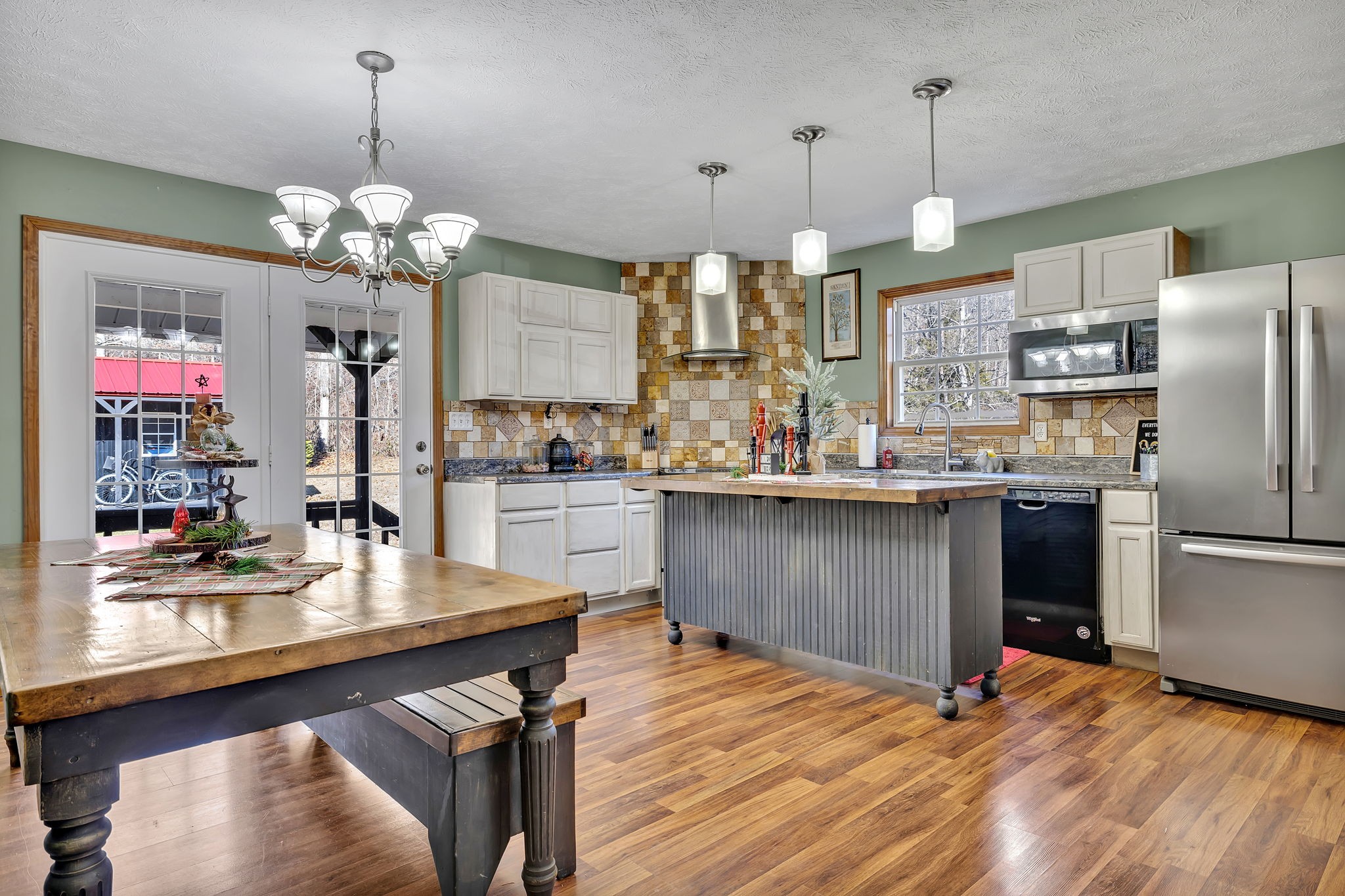 293 Slippery Road Hohenwald, TN 38462 - Photo 17 of 36 a kitchen with stainless steel appliances kitchen island granite countertop a table chairs and a chandelier