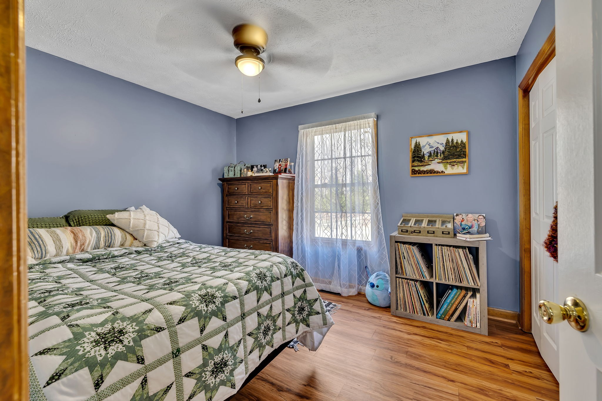 293 Slippery Road Hohenwald, TN 38462 - Photo 22 of 36 a bedroom with a bed and a book shelf
