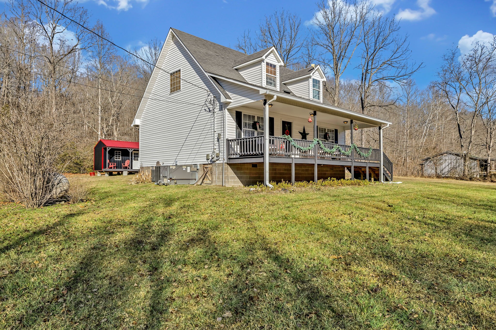 293 Slippery Road Hohenwald, TN 38462 - Photo 3 of 36 a view of a house with a backyard